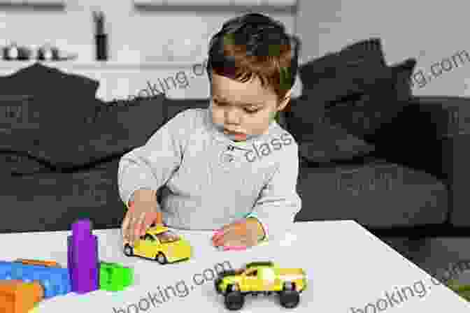 A Young Boy Sits At A Table, Playing With Toys. There S A Boy In Here Revised Edition: A Other And Son Tell The Story Of His Emergence From The Bonds Of Autism